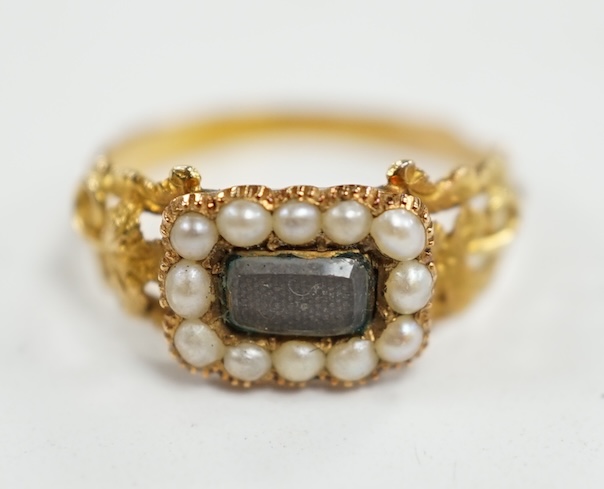 A 19th century yellow metal, seed pearl and plaited hair set mourning ring, the ring head verso inscribed 'In memory of a dear sister', size J, gross weight 1.4 grams. Condition - fair